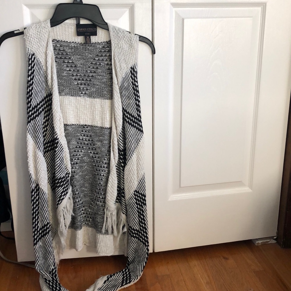 a black and white cardigan with no sleeves.